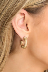 These gold earrings feature a textured design, worn gold finish, and secure post-back fastenings.