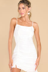 Front view of this dress that features a shimmery fabric, adjustable straps, and ruching along the sides.