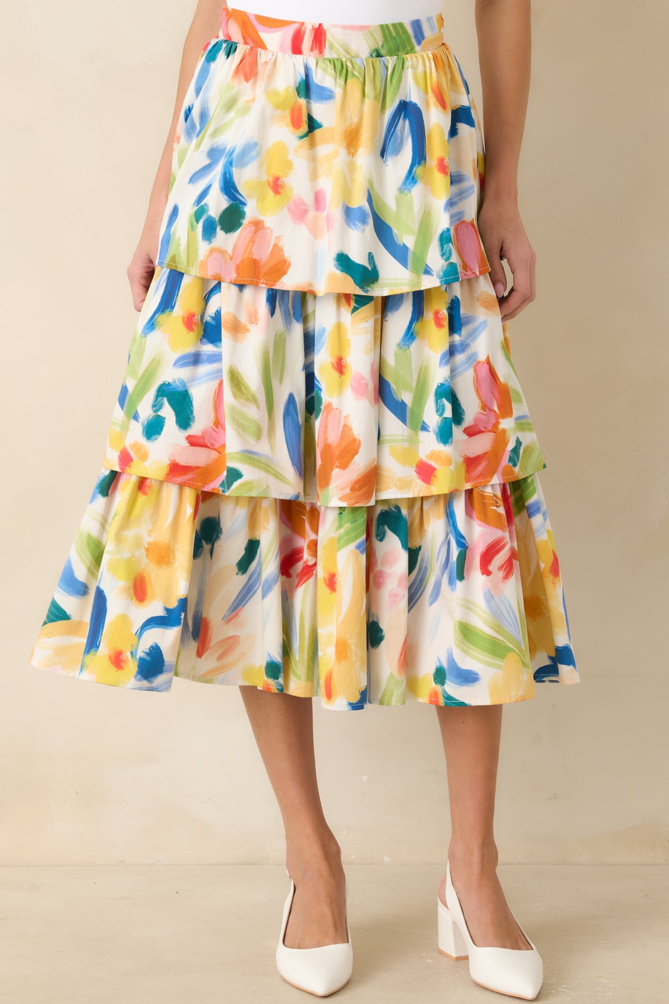 Colorful tiered skirt with abstract pattern on a plain background