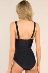 Back view of this swimsuit that features a v-neckline, a shelf bra, removable padding, adjustable straps, and cinching in the bodice. 