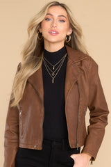 Front view of this jacket that features washed gold hardware, collar neckline with snap buttons, a front functional zipper, three functional zipper pockets, and slits on the sleeves with zipper closures.