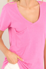 Close up view of this tee that features a v-neckline, a slouched breast pocket, a scooped hemline, and short sleeves.