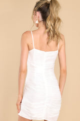 Back view of this dress that features a shimmery fabric, adjustable straps, and ruching along the sides.