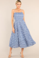 Full body view of this dress that features a wavy ruffled overlay. 