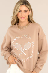 Front view of this oversized crewneck that sweatshirt featuring embroidered tennis racket icons and lettering, ribbed hems, and a crew neckline.