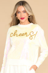 This front view showcases the iridescent sequins throughout the sweater.