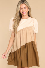 Front view of this dress that showcase the ombre tiers of the fabric that vary in shades of brown.
