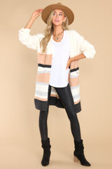Full body view of  this cardigan that features two functional pockets, and a soft material. 