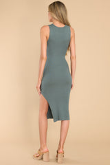 Back view of this dress that features a U-neckline, a slit in the left side reaching the mid-thigh, a bodycon silhouette, and a soft ribbed material throughout.