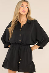 This all black romper features a collared neckline, functional buttons down the front, a self-tie drawstring waist, a lining underneath the shorts, and 3/4 length sleeves. 