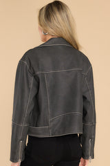 Back view of  this jacket that features a double breasted collar, zipper closure, zippered pockets, attached waist belt with buckle closure, and zippered sleeves.