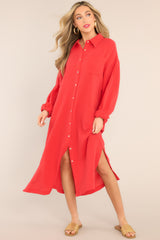 Full body view of this dress that features a collared neckline, functional buttons down the front, a front pocket on the left side of the bust, long sleeves with a cuff secured by a functional button, and two slits up the bottom hemline ending just below the knee.