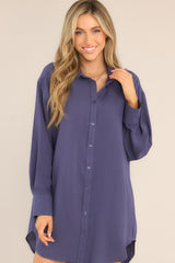 Front view of  this tunic that featuring a collared neckline, functional buttons down the front, long sleeves with buttoned cuffs, and a scoop bottom hem.