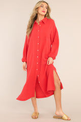 Front view of this dress that features a collared neckline, functional buttons down the front, a front pocket on the left side of the bust, long sleeves with a cuff secured by a functional button, and two slits up the bottom hemline ending just below the knee.
