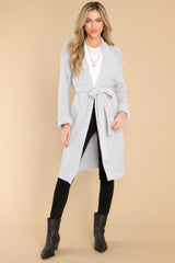 This grey cardigan features chunky knit fabric and a waist tie.