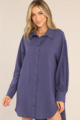 Front view of  this tunic that featuring functional buttons down the front and long sleeves with buttoned cuffs.