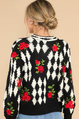 Back view of this cardigan that features a scoop ribbed neckline, functional buttons all the way down, and embroidered roses.