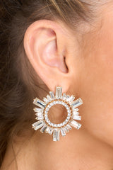 Front view of these earrings that feature gold hardware, a circular design, rhinestone detailing, and a secure post backing. 