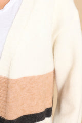 Close up view of this cardigan that features two functional pockets, and a soft material. 