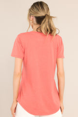 Back view of this tee that features a v-neckline, a slouched breast pocket, a scooped hemline, and short sleeves.