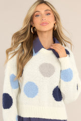 Front view of this sweater that features a blue polka dot design.