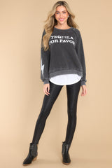 This black sweatshirt features a round neckline, long sleeves with ribbed cuffs, a ribbed bottom hem, and tequila-themed graphic lettering on the front and back.