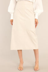 This bone colored skirt features a high waisted design, a side zipper, a slit in the back, and a faux leather material.