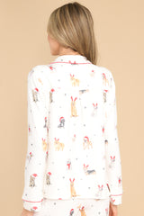 Back view of this top that features a collared neckline, functional buttons down the front, and a festive print.