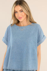 Front view of  this top that features a denim-like material.