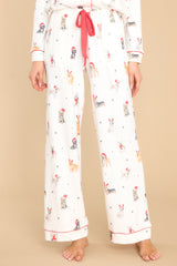 These ivory pants feature an elastic waistband, a self-tie drawstring, functional pockets, and a fun and festive print.