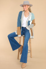 Full body view of this cardigan showcases the color-block pattern of the fabric in shades of blue, brown, grey, and white.