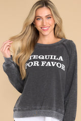 Front view of this sweatshirt that features a round neckline, long sleeves with ribbed cuffs, a ribbed bottom hem, and tequila-themed graphic lettering on the front and back.