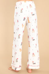 Back view of  these pants that feature an elastic waistband, a self-tie drawstring, functional pockets, and a fun and festive print.