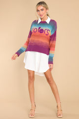 Full body view of this sweater that features a crew neckline, a ribbed hem, cuffed sleeves, and a colorful gradient pattern.