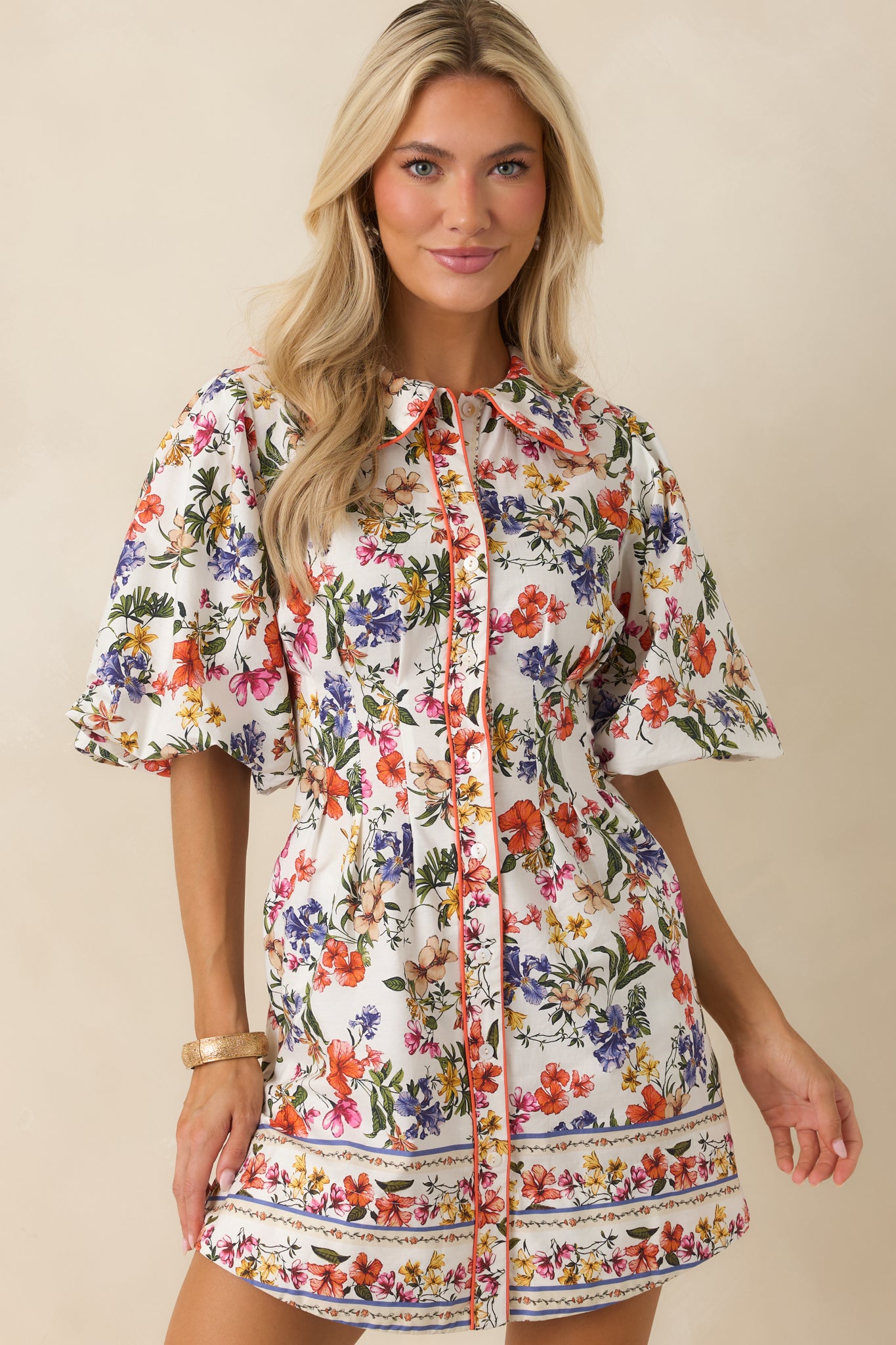 Ivory multi floral dress detailing side pockets integrated into the relaxed silhouette with soft gathers in the sleeve construction.