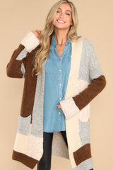 This multi-colored cardigan features color blocking, two functional pockets, and an oversize fit.