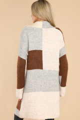 Back view of this cardigan that features color blocking, two functional pockets, and an oversize fit.