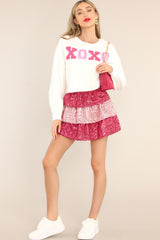 Full body view of this skirt that features a tiered pink sequin design, and a side zipper with hook & eye closure.