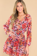 Front view of this dress that showcases the floral pattern in shades of pink and orange.