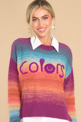 Front view of  this sweater that features a crew neckline, a ribbed hem, cuffed sleeves, and a colorful gradient pattern.