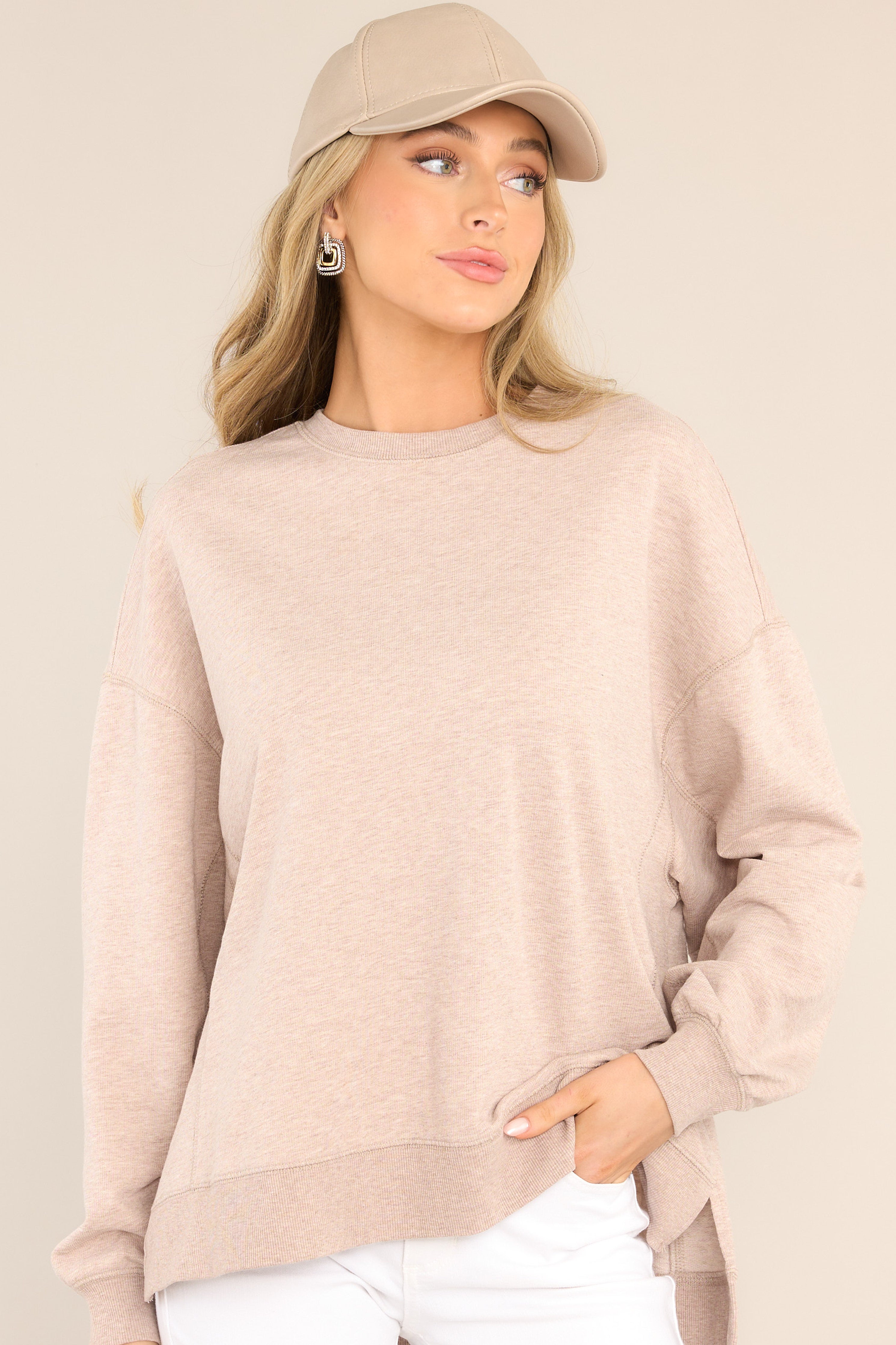Front view of this top that features a crew neckline, dropped shoulders, ribbed cuffed sleeves, and a high-low split hemline.