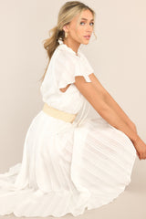 This ivory dress features a v-neckline with ruffle detailing and a self-tie feature, a self-tie waist belt, and a flowy skirt.