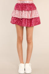 Close up view of this skirt that features a tiered pink sequin design, and a side zipper with hook & eye closure.