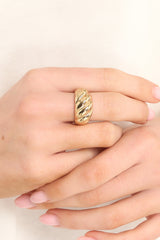 This gold ring features gold hardware and a ribbed design.