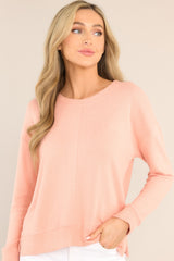Front view of this top that features a split bottom hem, a ribbed crew neckline and ribbed sleeve cuffs.