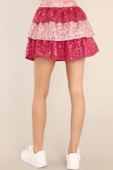 Back view of this skirt that features a tiered pink sequin design, and a side zipper with hook & eye closure.