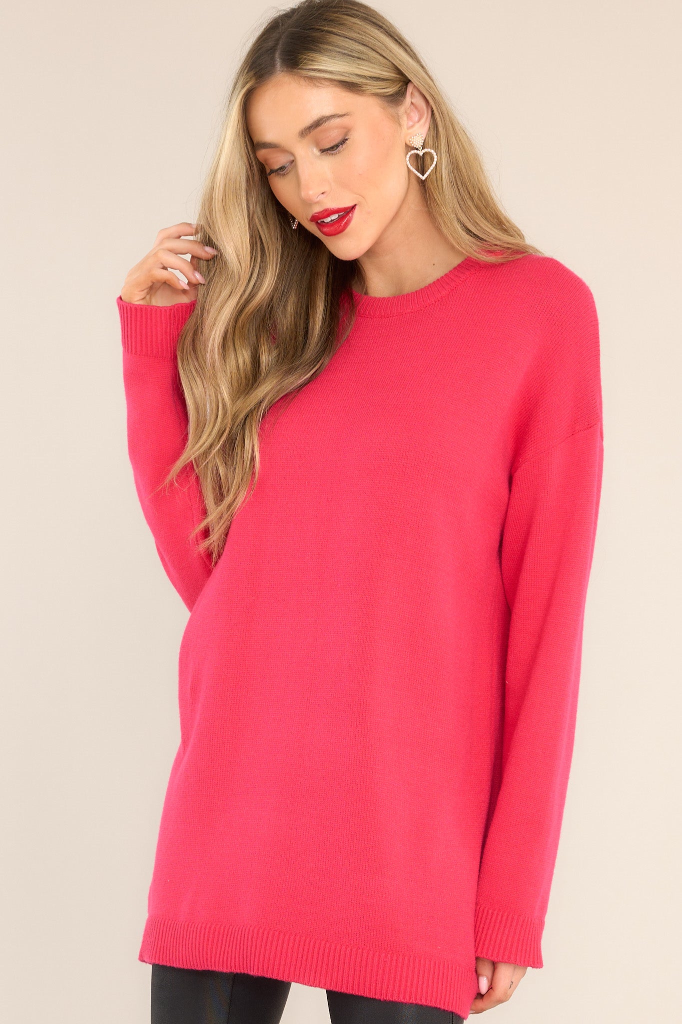 Front view of this sweater that features a round neckline, ribbed detailing around the neck and cuffs, soft material, and a relaxed fit.