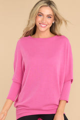 Front view of this top that features a round neckline and long dolman sleeves.
