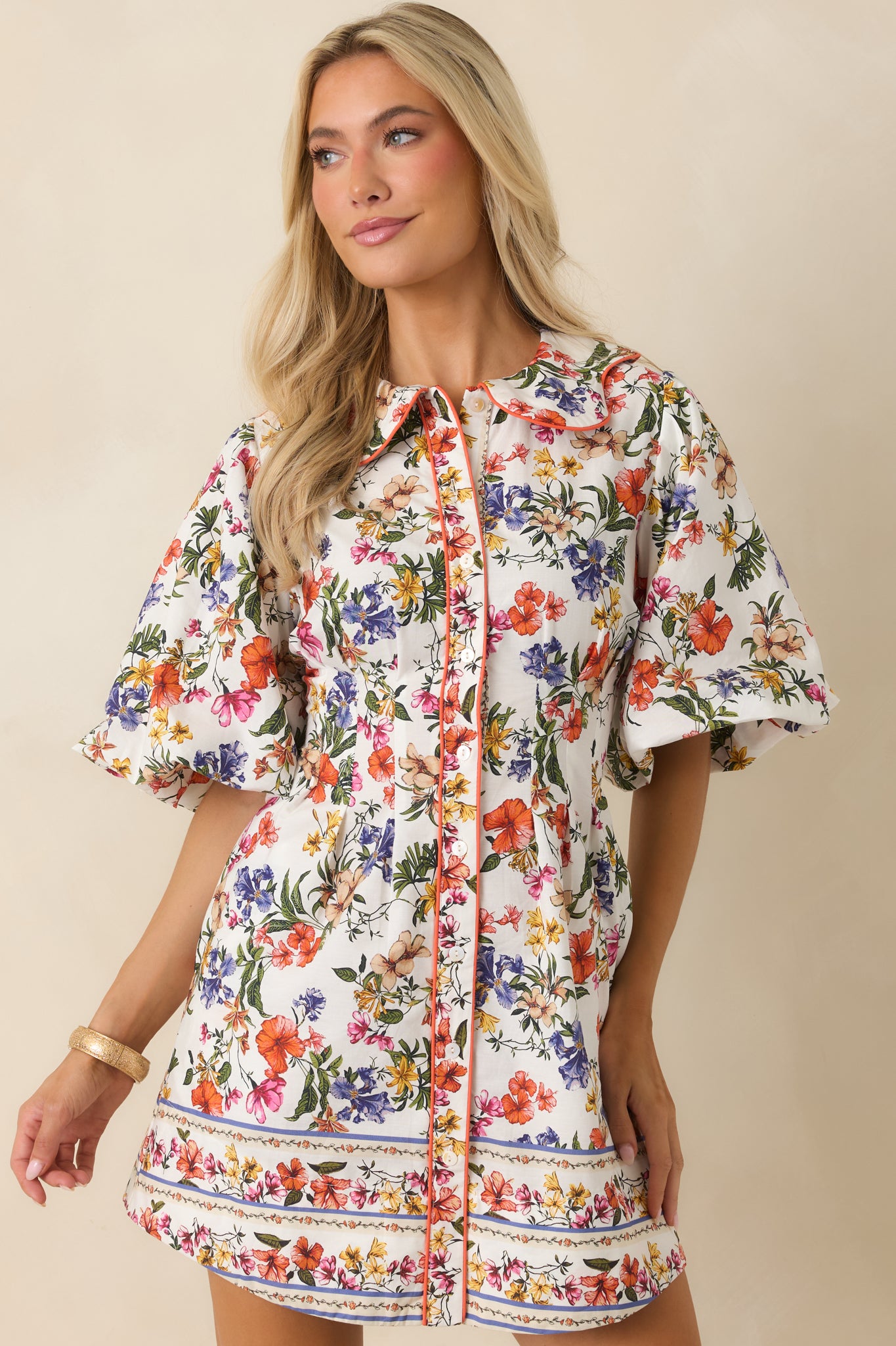 Floral cotton mini dress focusing on the voluminous bubble sleeves and smooth full lining that supports its airy structure.