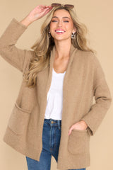 Front view of  this cardigan that features a folded collar, functional pockets, and side slits.